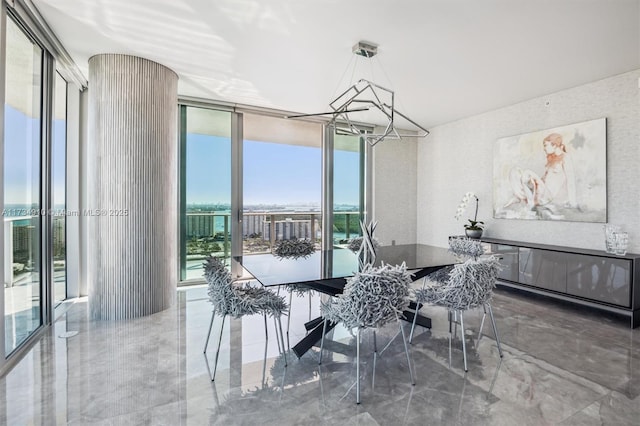 dining area featuring an inviting chandelier and floor to ceiling windows