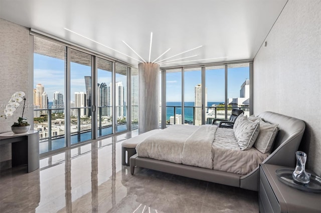 bedroom with a water view, floor to ceiling windows, and access to outside