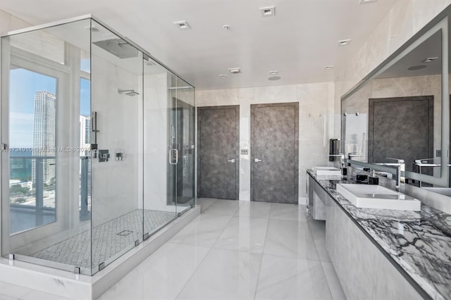 bathroom featuring tile walls, an enclosed shower, and vanity