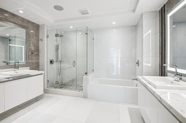 bathroom with tile patterned floors, vanity, plus walk in shower, and tile walls