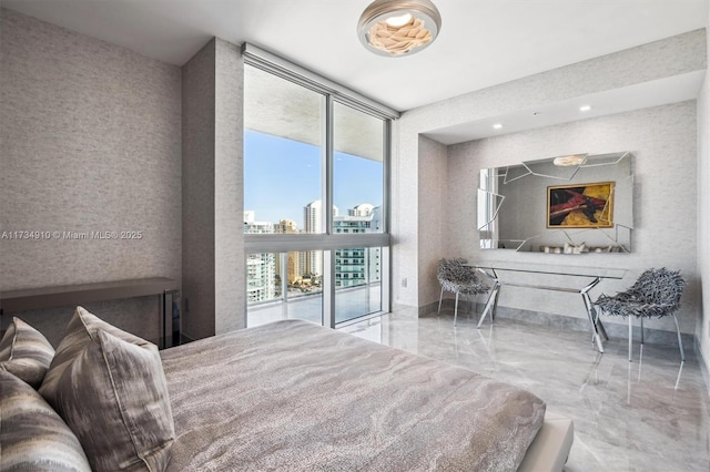 bedroom featuring a wall of windows and access to outside