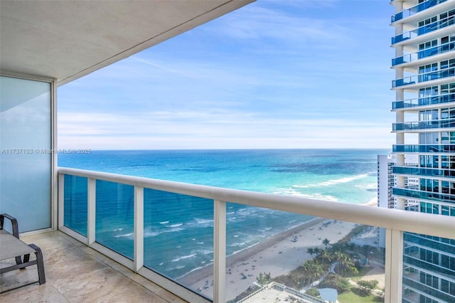 balcony with a water view and a beach view