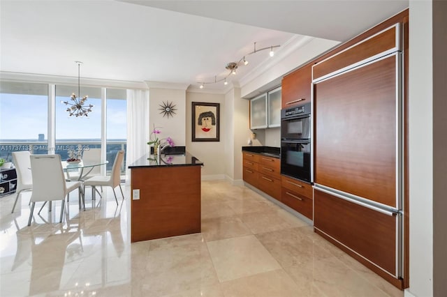 kitchen with decorative light fixtures, a wall of windows, ornamental molding, paneled built in fridge, and black double oven