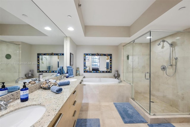 bathroom with independent shower and bath, vanity, tile patterned floors, and a tray ceiling