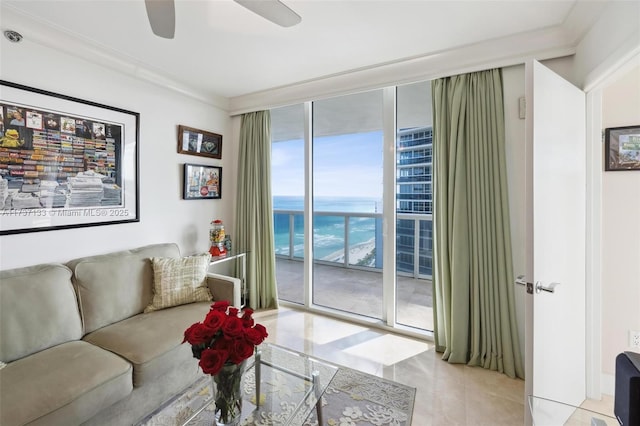 living room with light tile patterned floors, expansive windows, ceiling fan, and a water view