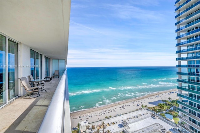 balcony with a view of the beach and a water view