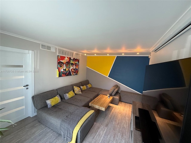 living room featuring crown molding and wood-type flooring