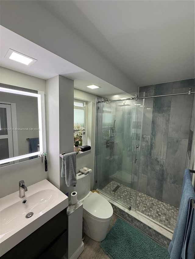 bathroom with vanity, toilet, and walk in shower