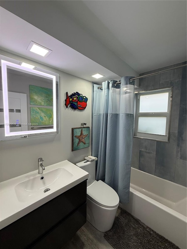 full bathroom with shower / bath combination with curtain, vanity, and toilet