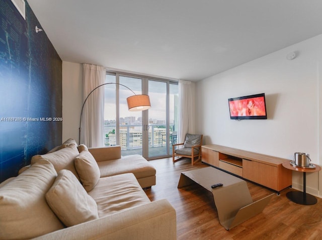 living room featuring expansive windows and wood-type flooring