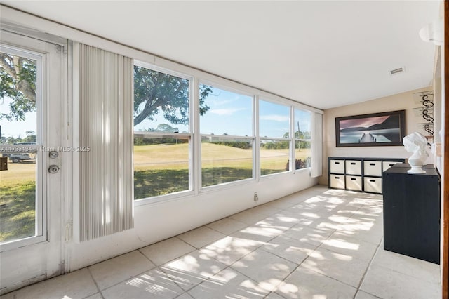 sunroom / solarium featuring vaulted ceiling