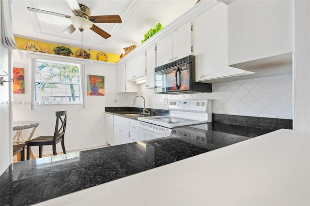 kitchen with sink, backsplash, white electric stove, and white cabinets