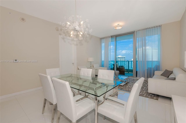 dining room featuring an inviting chandelier, expansive windows, and light tile patterned floors