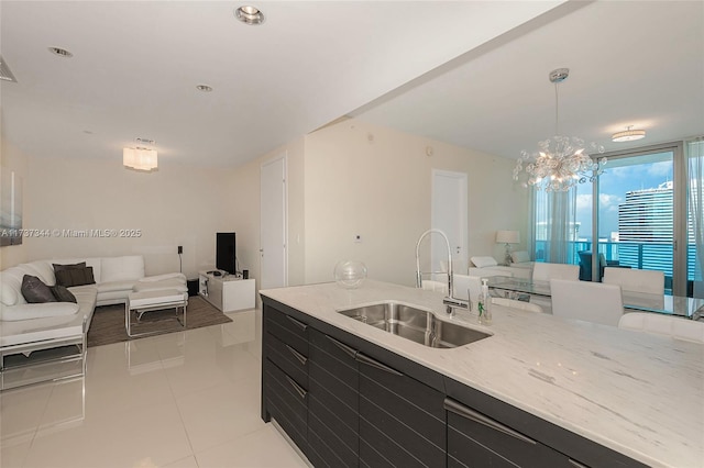 kitchen featuring pendant lighting, an inviting chandelier, sink, and light tile patterned floors