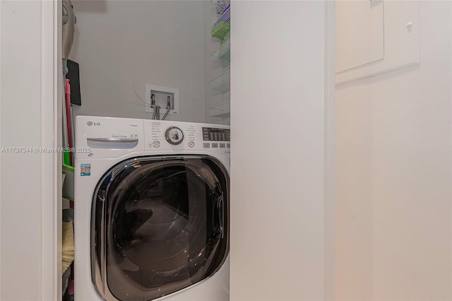 clothes washing area with washer / dryer