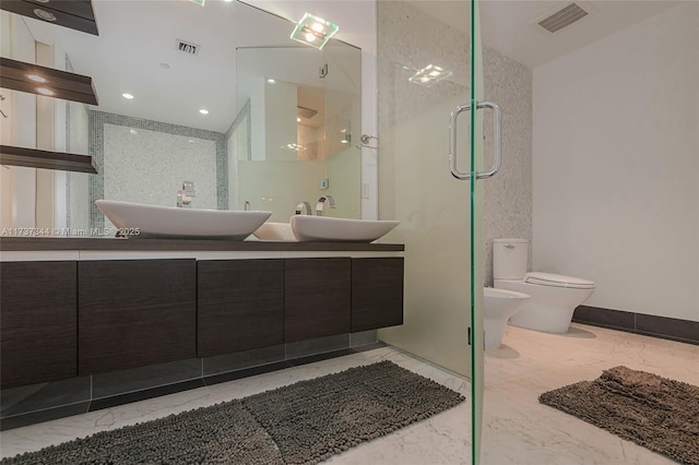 bathroom with a shower with door, vanity, a bidet, and toilet