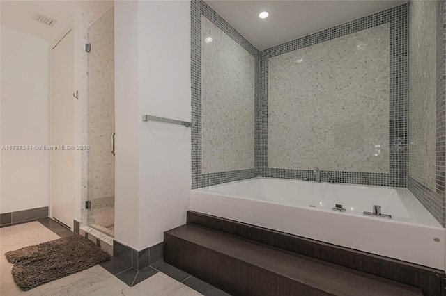 bathroom featuring shower with separate bathtub