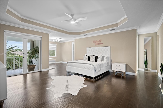 bedroom featuring ceiling fan with notable chandelier, access to exterior, a tray ceiling, crown molding, and dark wood-type flooring