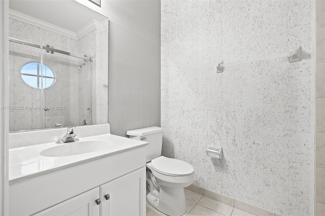 bathroom featuring tile patterned flooring, vanity, tiled shower, toilet, and crown molding