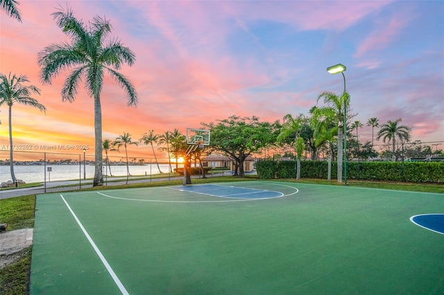 view of basketball court with a water view