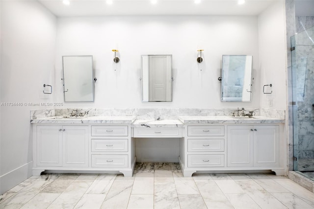 bathroom with vanity and a shower with shower door