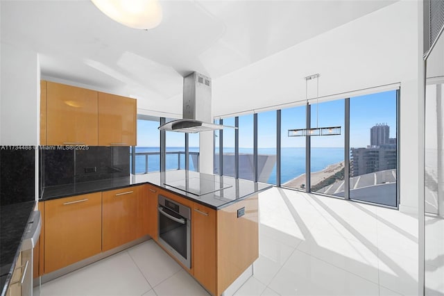 kitchen with a water view, island range hood, kitchen peninsula, black electric stovetop, and oven