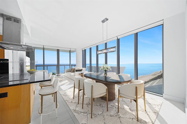 dining area with a water view and expansive windows