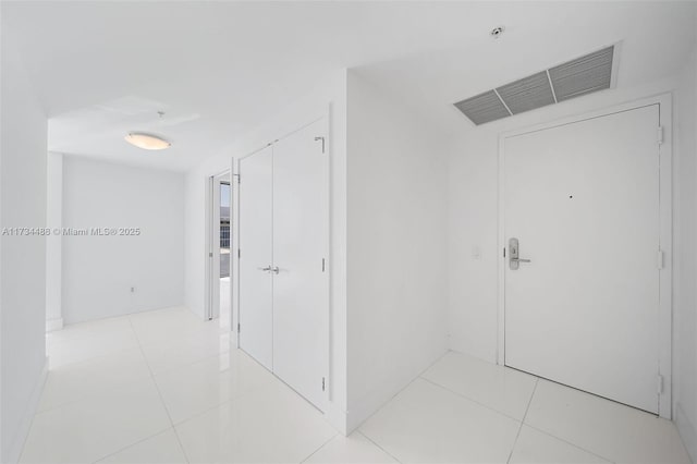 hallway featuring light tile patterned floors