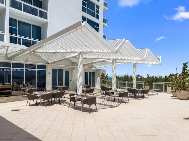 view of patio with fence, a pergola, and outdoor dining area
