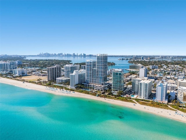 birds eye view of property with a beach view, a water view, and a view of city