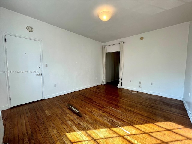 spare room with wood-type flooring