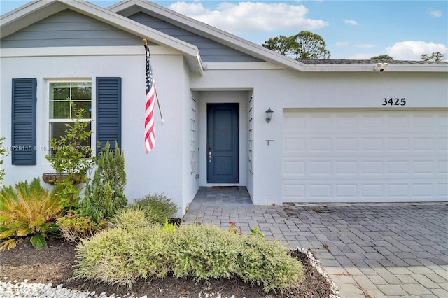 view of exterior entry with a garage