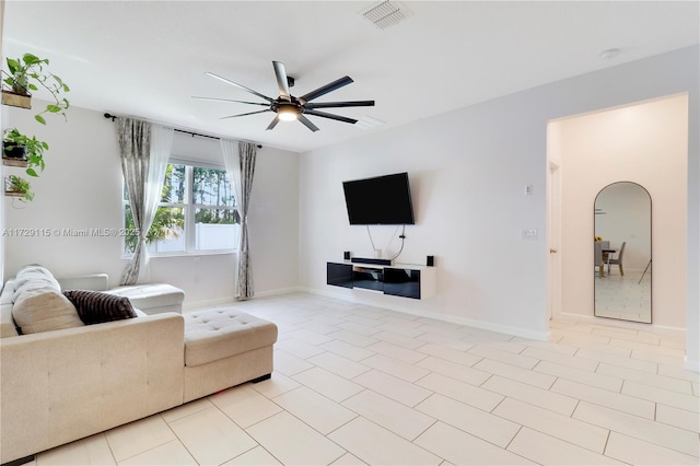 tiled living room featuring ceiling fan