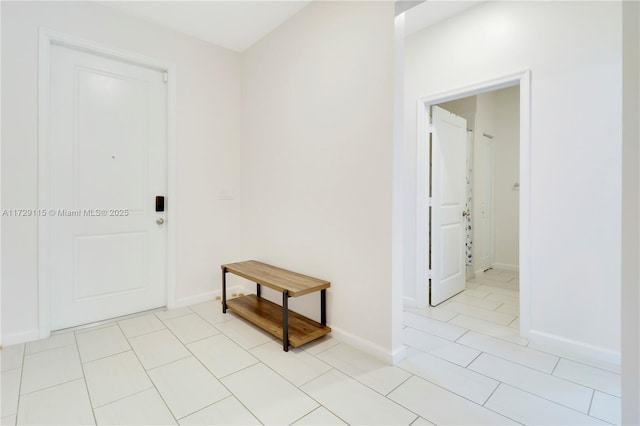 corridor featuring light tile patterned floors