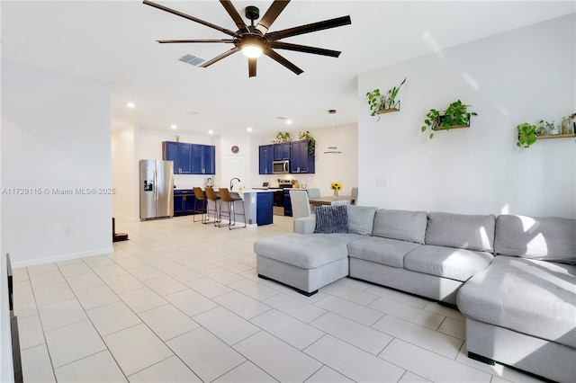 living room featuring sink and ceiling fan