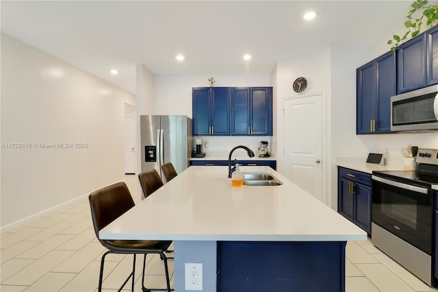 kitchen featuring appliances with stainless steel finishes, a kitchen island with sink, and a kitchen breakfast bar