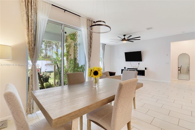 tiled dining space with ceiling fan