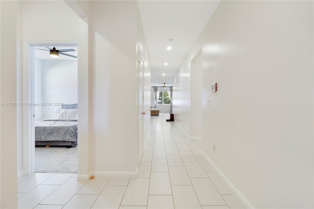 hall featuring light tile patterned flooring