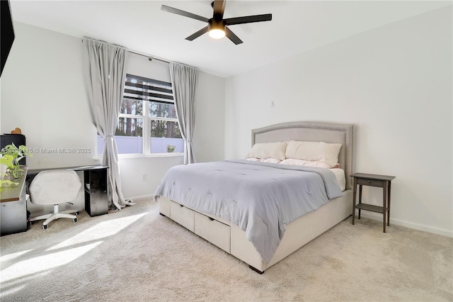 bedroom with ceiling fan and light carpet