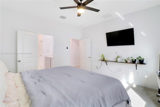 bedroom featuring connected bathroom, light colored carpet, and ceiling fan