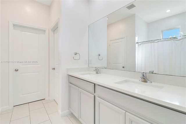 bathroom featuring vanity, tile patterned flooring, and walk in shower