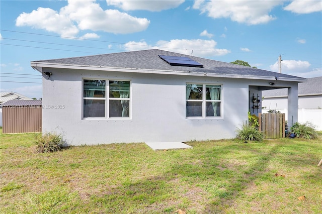 back of house featuring a lawn