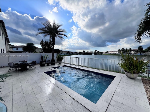 view of pool featuring a water view, outdoor dining space, a fenced backyard, and a patio