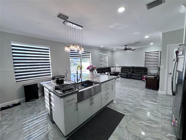 8654 W 33rd Ave, Hialeah, FL 33018 - kitchen featuring a sink, light marble finish flooring, a center island with sink, crown molding, and baseboards