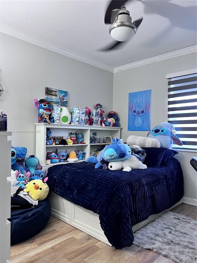 bedroom featuring crown molding, hardwood / wood-style floors, and ceiling fan