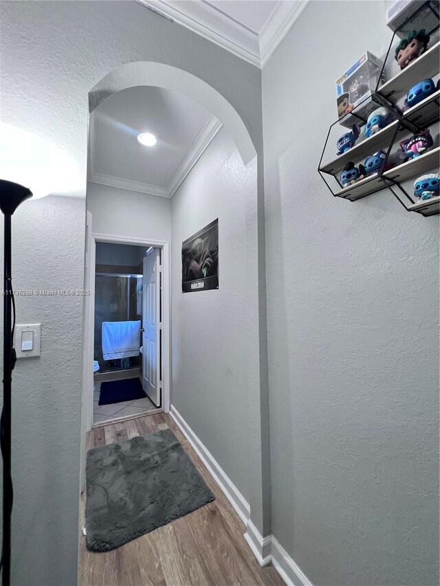 corridor featuring ornamental molding and hardwood / wood-style floors