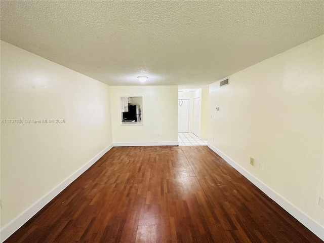 empty room featuring hardwood / wood-style floors and a textured ceiling