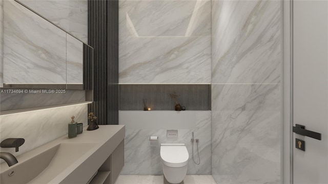 bathroom with vanity, toilet, and tile walls