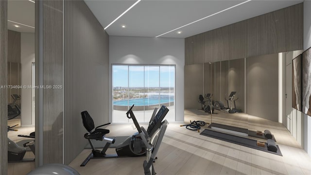 workout room featuring a towering ceiling