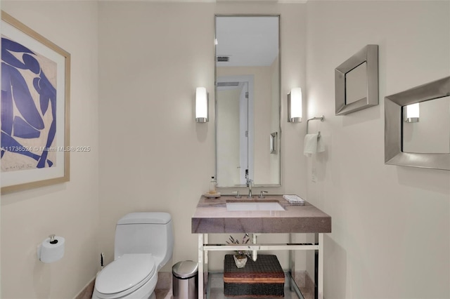 bathroom featuring toilet and sink